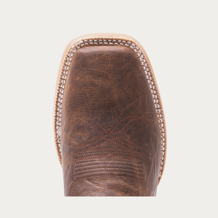 Toe of brown cowboy boot with tonal stitching on light gray background