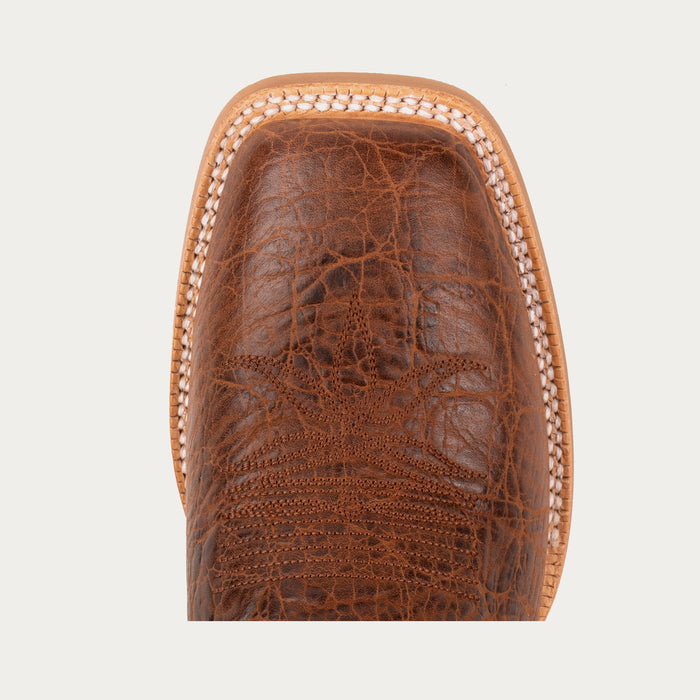 Close-up of a brown leather boot sole with intricate texture on a light gray background
