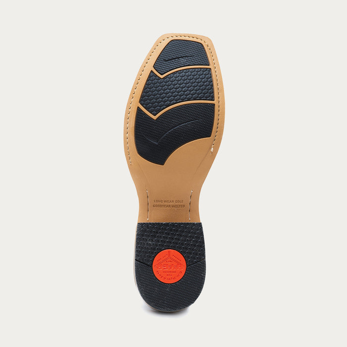 Tan cowboy boot sole with black rubber insets and a red heel cap on a light gray background