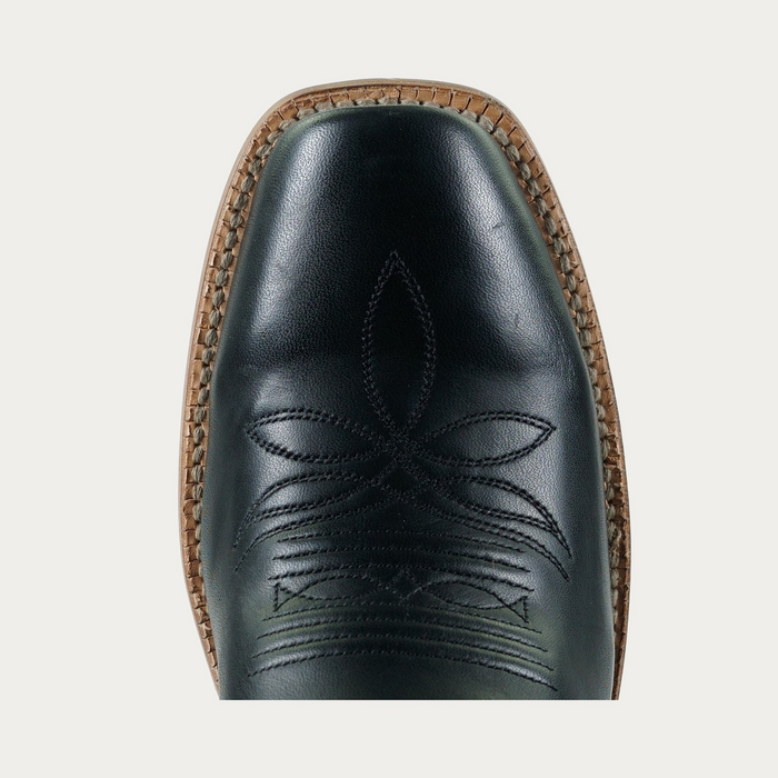 Detail, close up image of toe of a black cowboy boot