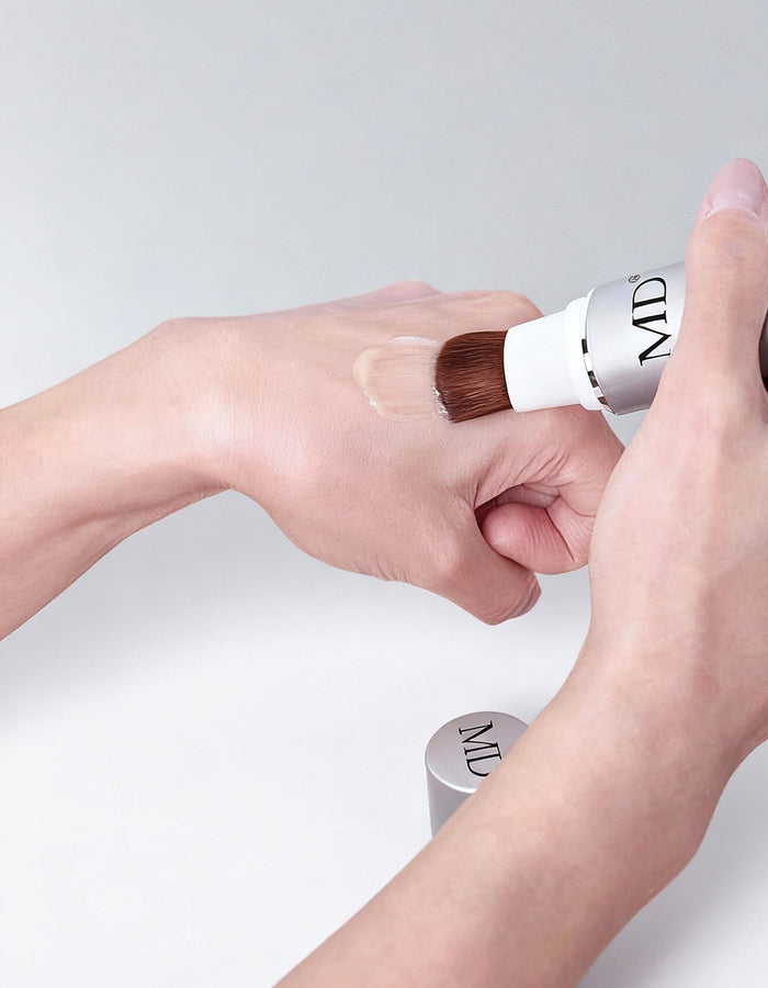 Swatch of MD® Follicle Energizer peptide serum applied with its precision brush applicator