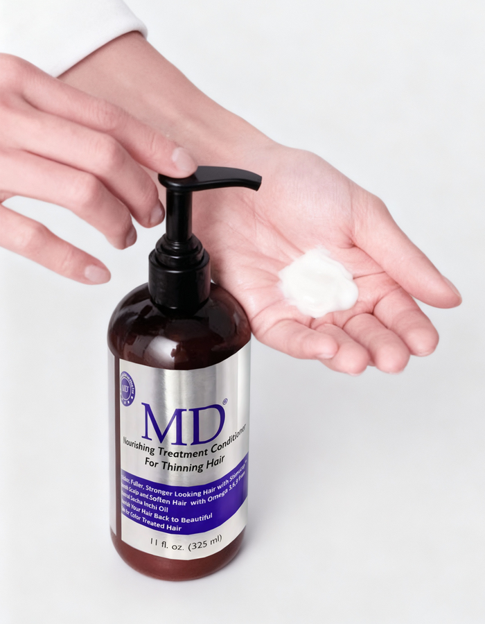 Applying MD® Revitalizing Treatment Conditioner. Weightless repair formula for fine and damaged hair.