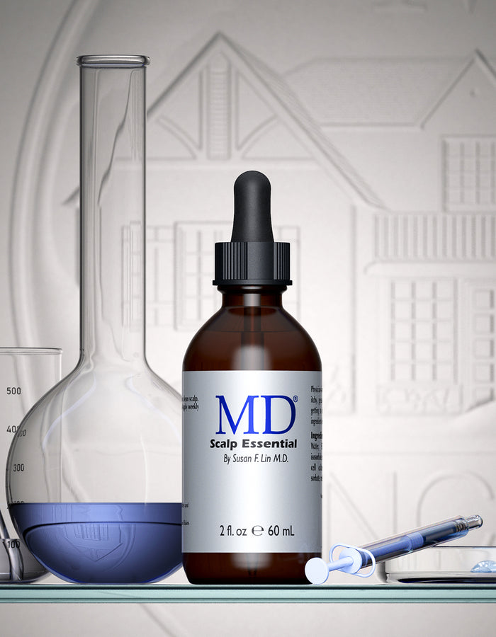 MD® Scalp Essential scalp serum bottle beside laboratory glassware