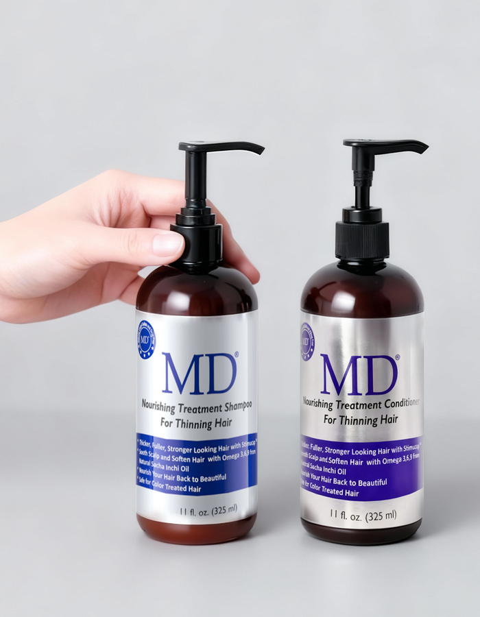 Hand holding MD Revitalizing Treatment Shampoo and Conditioner from MD Hair, for fine hair and scalp care