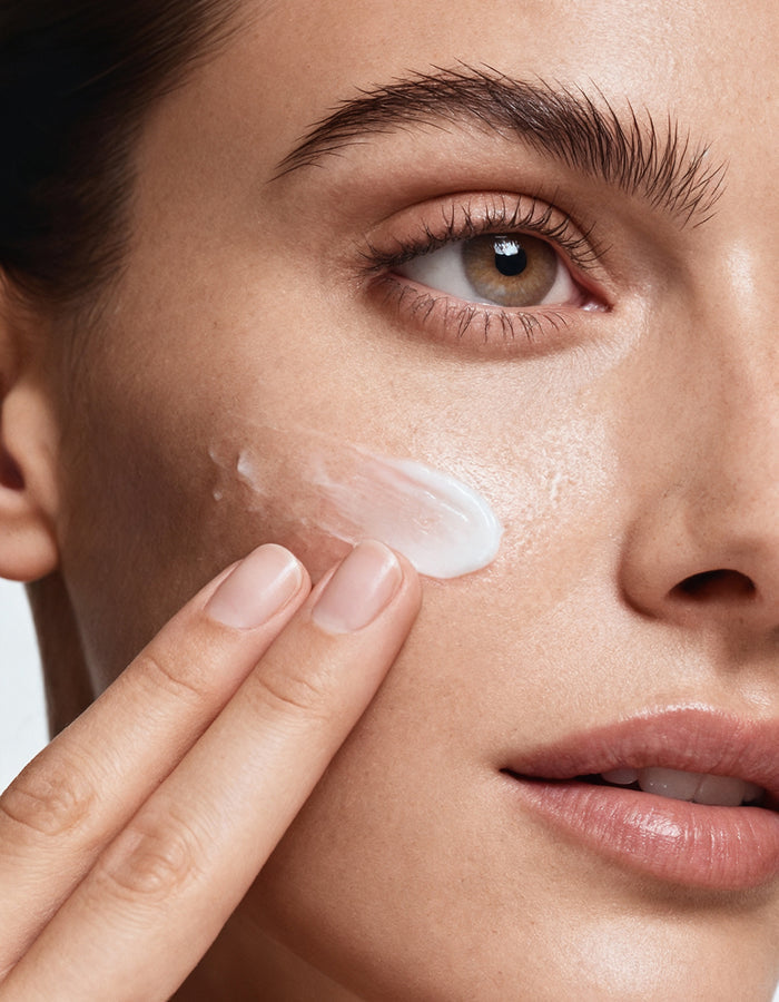 Model applying MD Ultimate White hydroquinone-free skin whitening cream to brighten dark spots and even skin tone naturally.