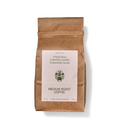 A brown paper coffee bag stands upright.