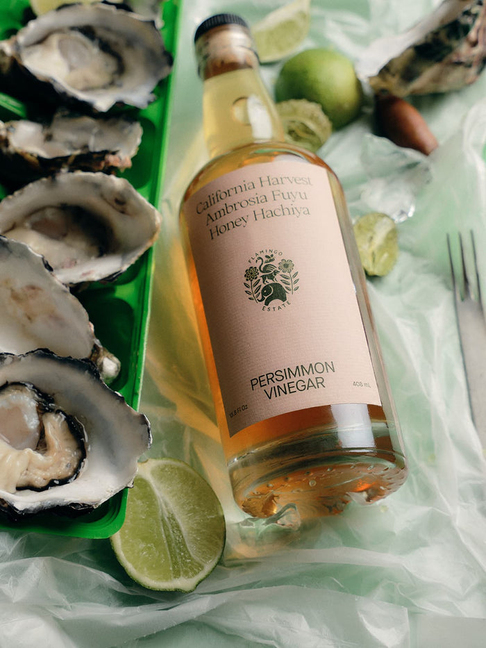 A bottle labeled "California Harvest Ambrosia Fuyu Honey Hachiya Persimmon Vinegar."