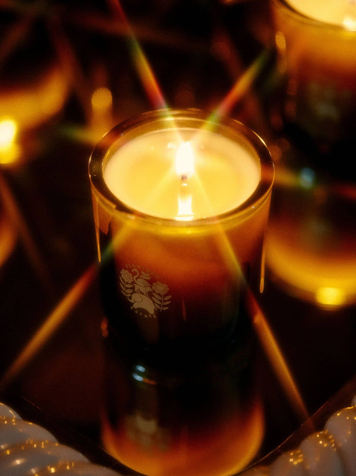 Sage Candle burning with a warm glow, highlighting its calming, aromatic quality.