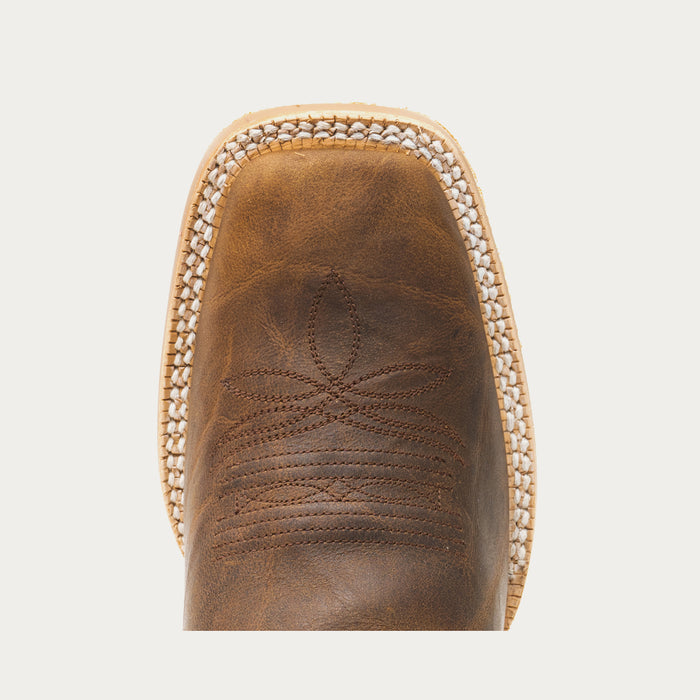 Close-up of a brown leather boot with decorative stitching on a light gray background