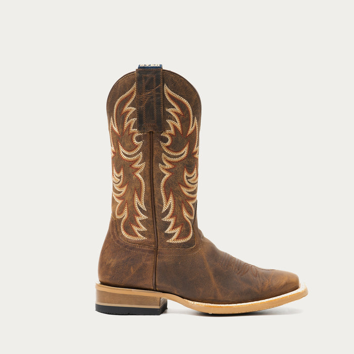Brown cowboy boot with intricate stitching on a light gray background